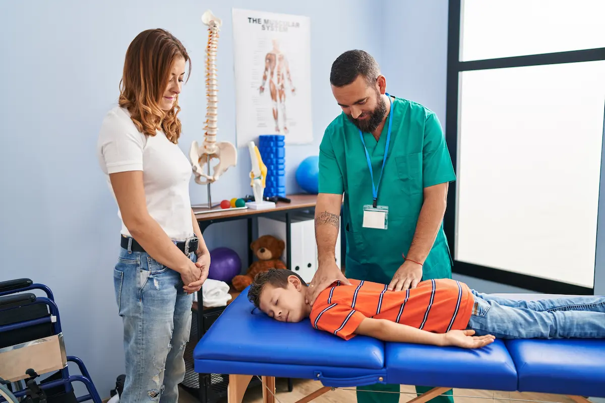 Child receiving chiropractic adjustment from chiropractor